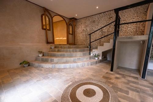 a lobby with stairs and a rug on the floor at Penida Patio Hostel in Toyapakeh