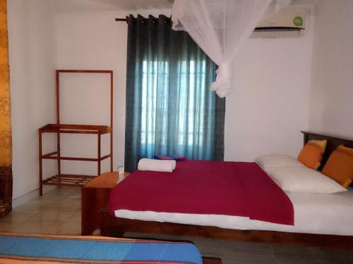 a bedroom with a large bed and a window at Sky Villa Sigiriya in Sigiriya