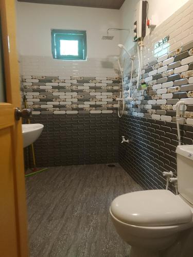 a bathroom with a toilet and a sink at Sky Villa Sigiriya in Sigiriya