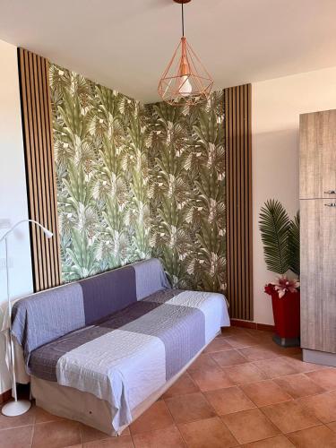 a bedroom with a bed and a wall with a mural at Torre Sances Holiday Apartament in Birgi Vecchi