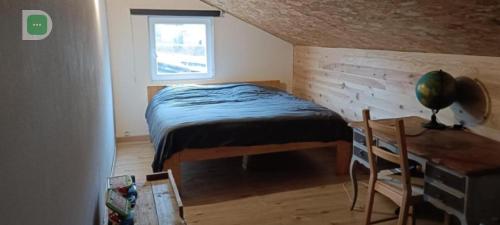 a small bedroom with a bed and a window at Chalet 5 personnes avec piscine in Yvoir