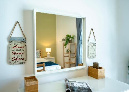 a mirror in a room with a bed and a bedroom at Maison Privee - Modern Yas Island Escape with Peaceful Canal Views in Yas Island