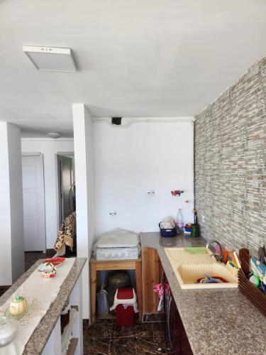 a kitchen with marble counter tops and a brick wall at Beautiful F3 with Sea View in La Reghaia/Boudouaou