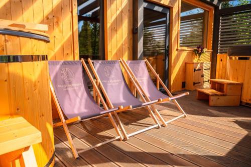 two lawn chairs sitting on a porch of a cabin at Chata Przesieka in Przesieka