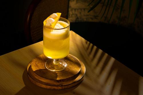 a drink sitting on a table with a wooden coaster at Mango Hotels Prangan in Bhubaneshwar