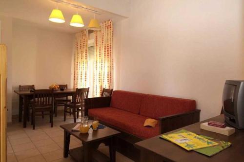 un salon avec un canapé rouge et une table dans l'établissement Villa 3 étoiles - Piscine - eeidhb, à Prayssac