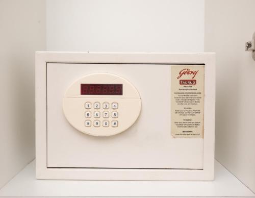 a microwave with a digital clock on top of it at Kaira Park in Chennai