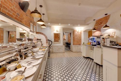a large kitchen with many sinks and a counter at Hotel Diament Plaza Gliwice in Gliwice