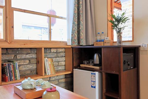 a kitchen with a small refrigerator and a window at Mild Spring Boutique Hotel in Huangshan