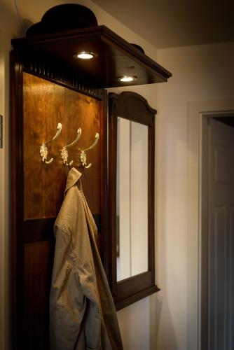 a mirror and a robe hanging on a wall at Zweitraum in Oldenburg in Oldenburg
