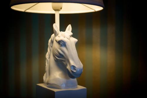 a lamp with a white horse head on a table at Zweitraum in Oldenburg in Oldenburg