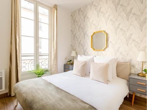 Posteľ alebo postele v izbe v ubytovaní Cozy Apartment - Opera - Caumartin I