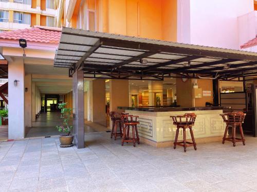a patio with a bar with stools around it at Eastern Grand Palace in Pattaya South