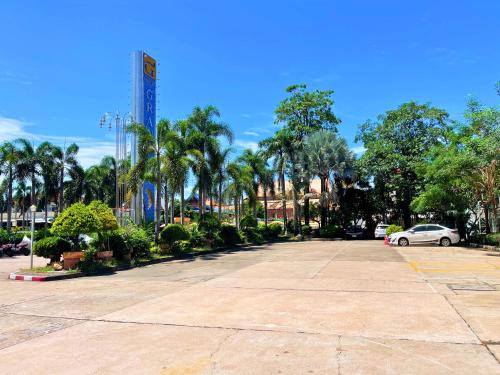 a car parked in a parking lot with palm trees at Eastern Grand Palace in Pattaya South