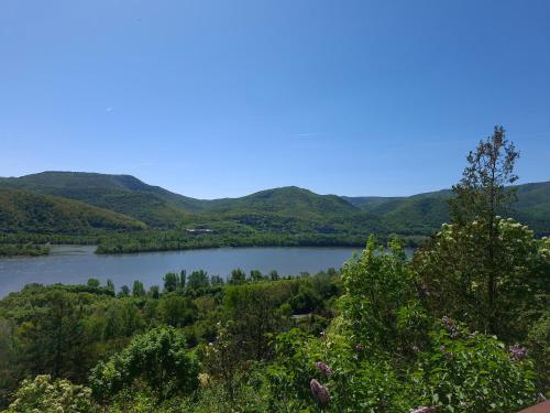 a view of a lake with mountains in the background at Sherpa Pihenőház in Nagymaros