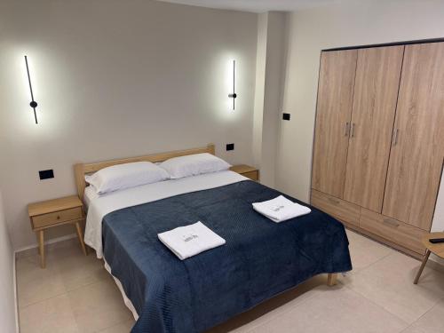 a bedroom with a bed with two towels on it at Cozy Double Room in City Center in Shkodër