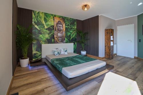 a bedroom with a large bed with a painting on the wall at Home of spa in Mainz