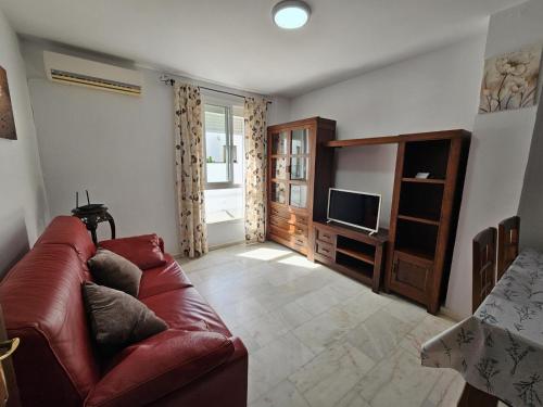 a living room with a couch and a television at ref. 60 casa chana in Zahara de los Atunes