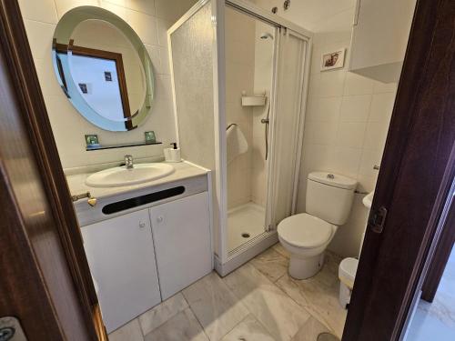 a bathroom with a sink and a toilet and a mirror at ref. 60 casa chana in Zahara de los Atunes