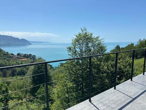a balcony with a view of the water at Cottage KOLKHA in Sarpi