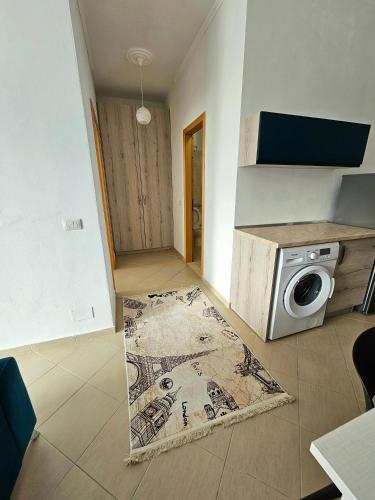 a living room with a microwave and a rug at Vlora Beach Apartment Orikum in Orikum