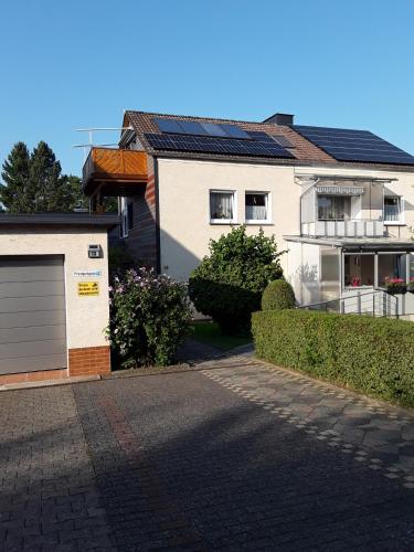 a house with a garage in front of it at Fewo 1 in Beverungen