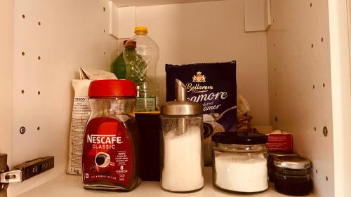 a kitchen counter with some food items in a refrigerator at Strigonia Apartman in Esztergom
