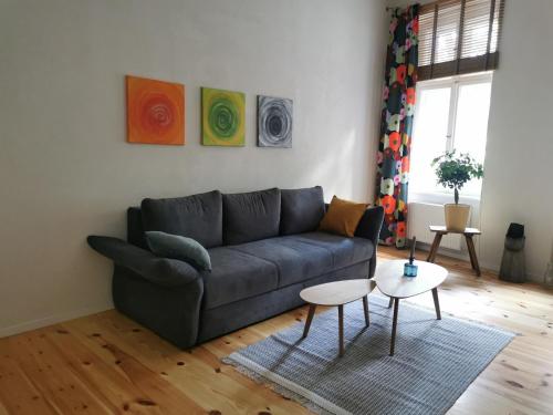 a living room with a couch and a table at Ferienwohnung Potsdam in Potsdam