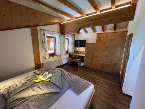 a bedroom with a bed in a room with wooden ceilings at ALPENHOTEL TYROL - B&B - ADULTS ONLY - Alpines Lifestyle-Konzepthotel - dog friendly in Pertisau