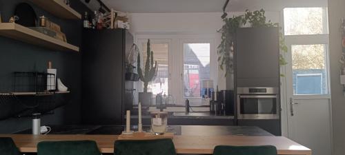 a kitchen with a table with chairs and a counter top at Comfortable, cozy house 20 min to Amsterdam in Zaandam