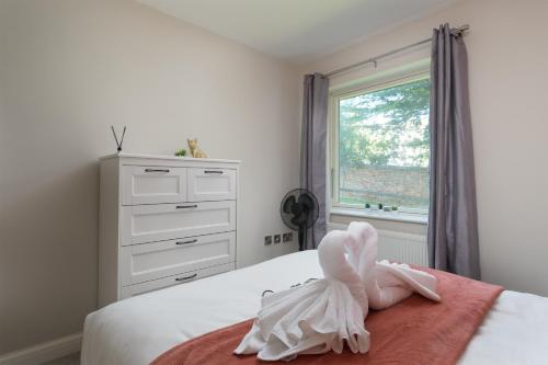 a bedroom with a bed with towel animals on it at Perfect for Silverstone Free Parking Stylish 2BR in Buckingham