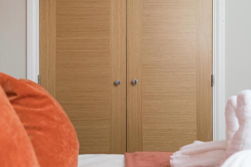 a close up of a wooden door in a bedroom at Perfect for Silverstone Free Parking Stylish 2BR in Buckingham