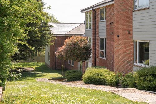 a brick house with a yard in front of it at Perfect for Silverstone Free Parking Stylish 2BR in Buckingham
