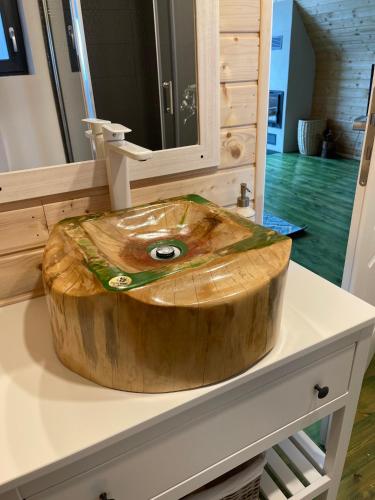 a large wooden bowl sitting on top of a counter at Casa Boema- La noi la munte in Mătişeşti