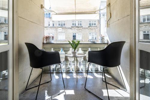 a room with a table and chairs and a window at Grand Suborna Retreat in Sofia