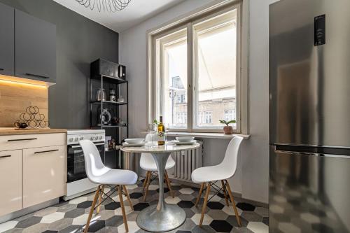 a kitchen with a table and chairs and a refrigerator at Grand Suborna Retreat in Sofia