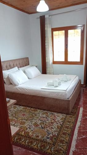 a bedroom with a bed with two towels on it at Villa Rexho in Berat