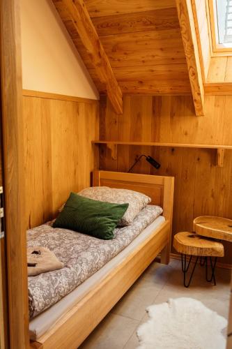 a bedroom with a bed in a wooden room at Świerkowe Chatki w Koniakowie in Koniaków