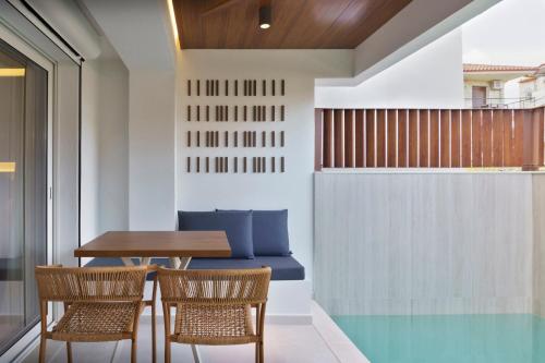 a dining room with a table and chairs at Palm Boutique Suites in Pefkohori