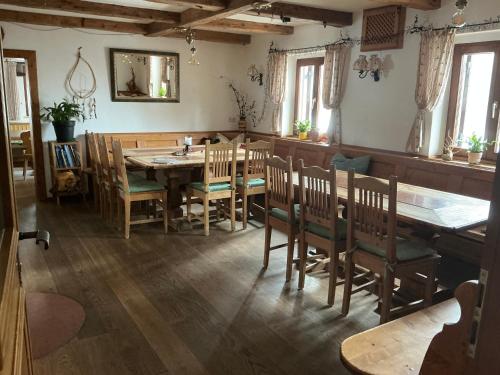 a dining room with a wooden table and chairs at Halleinerhaus by Soul Rebels in Größing