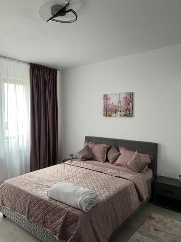a bedroom with a bed and a ceiling fan at Apartament sector 5 Sara in Bucharest
