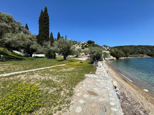 a path along a beach next to a body of water at Kerveli Coast in Samos