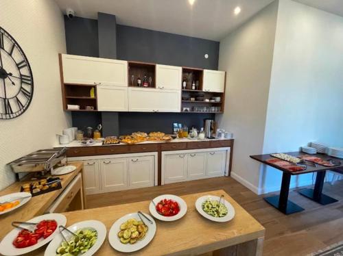 a kitchen with plates of food on a table at Lux Apartment 14 in Kravlja