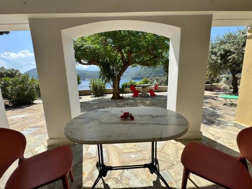 a table in the middle of a room with a view at Kerveli Coast in Samos