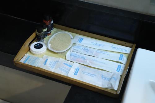 a tray with toilet paper and other items on it at The Citiotel, Shivaji Nagar in Pune
