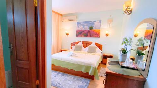 a hotel room with a bed and a mirror at Pensiunea Roșu Litoral in Douăzeci şi Trei August