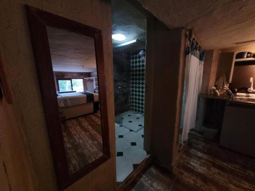 a view of a room with a mirror and a bedroom at Casa Rover - Floripa in Florianópolis