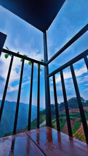 a room with a table with a view of the mountains at Scasa Glamping in Kodaikānāl