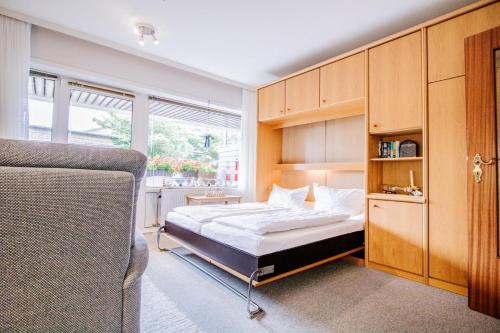 a bedroom with a bed and a large window at Ornum, App. 2 in Westerland (Sylt)