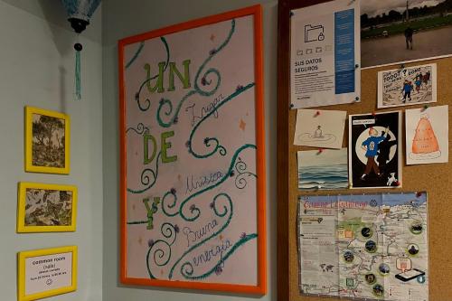 a bulletin board with writing on a wall at Santander Central Hostel in Santander